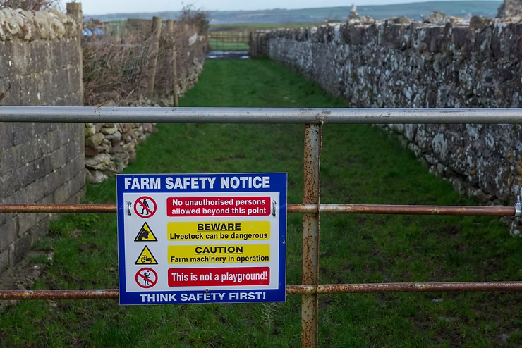 Farm safety notice sign on gate of a rural farm in the republic of Ireland