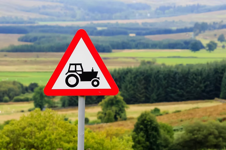 Triangle road sign warning of farm traffic
